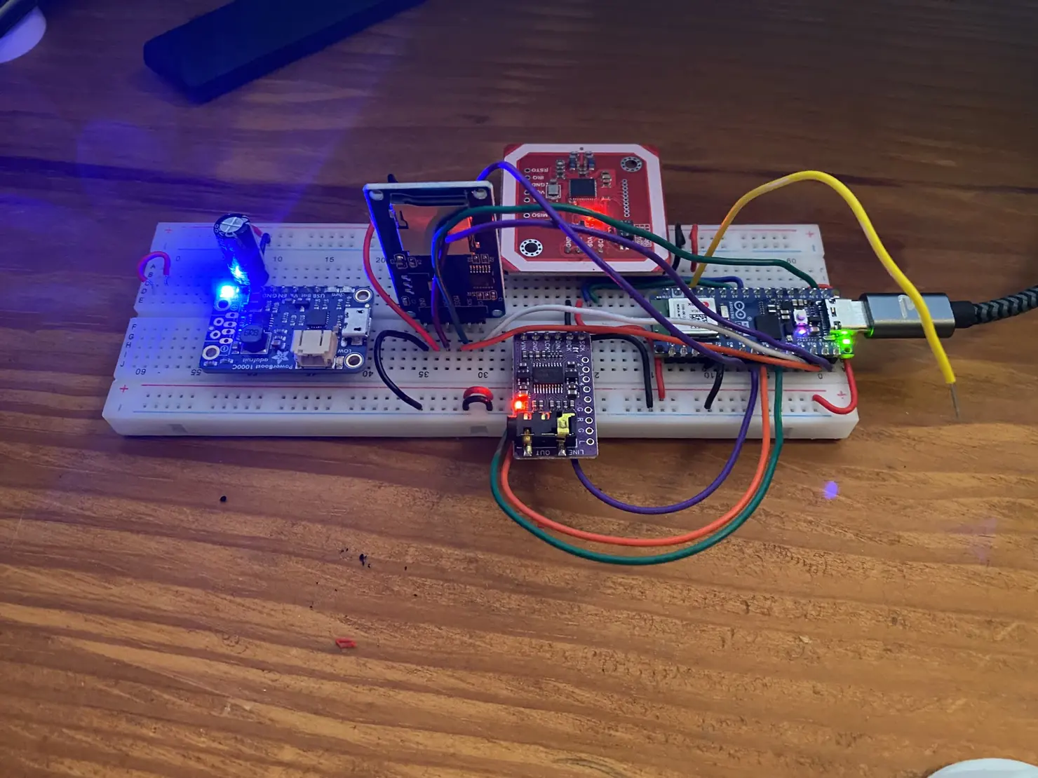 The heart of the box on a breadboard: an ESP32-S3, an NFC reader, an audio amp, and everything wired together.